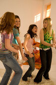 Four teenage girls (14-16) dancing