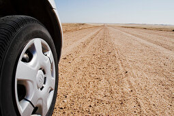 Car tyre and dirt track, also called pad, Namibia, Africa