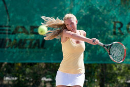 Young woman playing tennis, Apulia, Italy