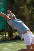 Male tennis player celebrating on court, Apulia, Italy