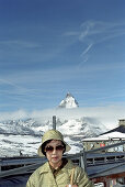 Asian tourist in front of the Matterhorn, Zermatt, Switzerland