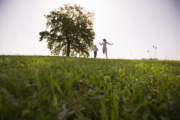 Couple running on meadow