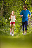 Couple jogging in woods