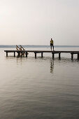 Young woman standing on jetty