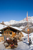 People sitting in front of Fondue Hut of the restaurant Hohnegg, Saas-Fee, Valais, Switzerland