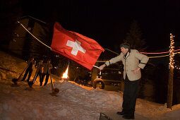 A flagswinger and swiss horn players at night, Saas-Fee, Valais, Switzerland