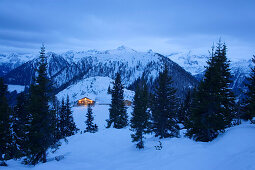 View to illuminated alpine hut (Hochwurzenalm), Schladming, Ski Amade, Styria, Austria