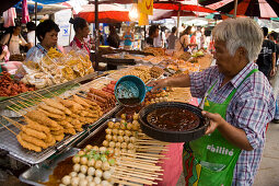 Woman preparing Thai food at Suan Chatuchak Weekend Market, Bangkok, Thailand