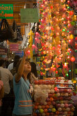 Young woman choosing a fairy lights at Suan Chatuchak Weekend Market, Bangkok, Thailand