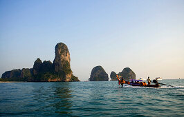 Longtail boat to Railay West with chalk cliff, Laem Phra Nang, Railay, Krabi, Thailand