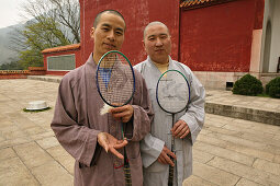 two monks with badminton racquets in courtyard, Fuyan monastery, Heng Shan south, Hunan province, Hengshan, Mount Heng, China, Asia