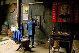 village barber, Mao portrait, courtyard of timber house in Chengkan, ancient village, living museum, Chengkan near Huangshan, Anui, China, Asia