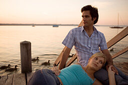 Young woman resting with head on man's lap