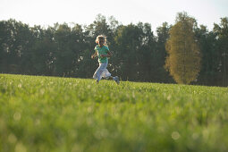 Girl running over meadow