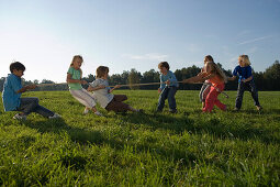 Children playing tug-of-war, children's birthday party
