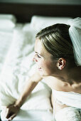 Bride sitting on the bed, high angle view