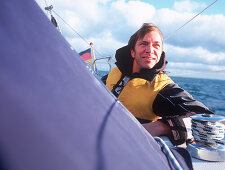 Man wearing lifejacket on sailboat, Bay of Kiel between Germany and Denmark