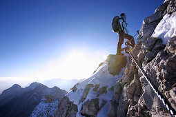 Man walking to the summit of the Zugspitze in the morning, Bavaria, Germany
