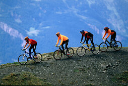 Four people on a mountainbike tour, Arosa, Grisons, Switzerland, Europe