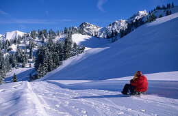 sledging at hut Unterpartnomalpe, Sonnntag, Vorarlberg, Austria