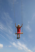 Girl (5-6 years) on a swing