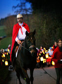 Children carrying lanterns for the St. Martin festival with St. Martin on a horse, Degerndorf, Upper Bavaria, Germany