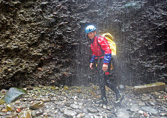 Man walking throuhg gorge, swim and hike canyon Raebloch, Emmental valley, Canton of Bern, Switzerland, MR