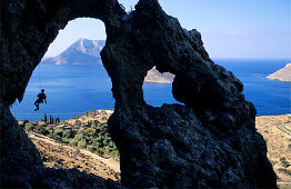 Kalymnos, Greece, Aegean Sea, a climber abseils in a cave above the sea. Kalymnos, Greece, Aegean Sea, Europe