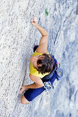 Young woman freeclimbing on rock, European Alps, MR