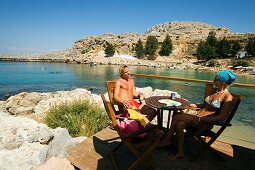 Couple in Beach Bar  Saint Paul's Bay (Agios Pavlos), Lindos, Rhodes, Greece