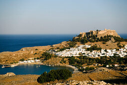 Elevated view of Lindos Bay and town with Acropolis, Lindos, Rhodes, Greece
