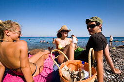 Group of young people sunbathing at Gennadi beach, Gennadi, Rhodes, Greece