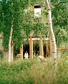 Woman in bathrobe standing at window, Hotel Neuklostersee, Mecklenburg-Western Pomerania, Germany, MR, PR