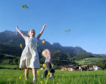 Girl and boy playing on mountain pasture, Leogang, Salzburg (state), Austria
