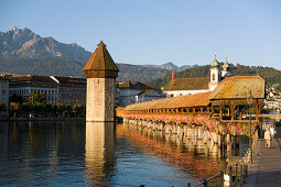 River Reuss with Kapellbrücke (chapel bridge, oldest covered bridge of Europe) and Wasserturm, Jesuit church, first large sacral baroque building in Switzerland, Pilatus in background, Lucerne, Canton Lucerne, Switzerland