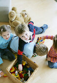 Children playing with plastic bricks and toys
