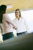 Two women shaking hands