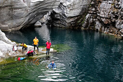 A group of people swims, through the Maggia Canyon, Valle Maggia, Tessin, South Switzerland