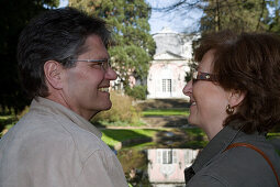 Mature adult couple smiling at each other, Benrath castle, Düsseldorf, state capital of NRW, North-Rhine-Westphalia, Germany