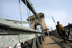 People walking over The Chain Bridge, Budapest, Hungary