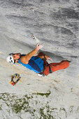 Man free climbing at rock formation, Raetikon range, Grisons, Switzerland
