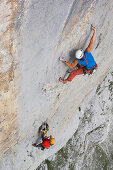 Man free climbing at rock formation, Raetikon range, Grisons, Switzerland