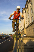 Biker driving over metal gate, Linz, Upper Austria, Austria