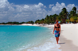 Woman walks on sandy beach, Punta Cana, Caribbean, Dominican Republic