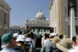 Tourist on the upper deck of a sightseeing bus looking at Saint Peters Cathedral, Rome, Italy