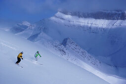 Two skiers in deep snow, Lake Louise, Alberta, Canada