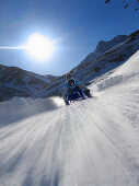 Mother and son on sledge, Lazaun run, Schnals Valley, South Tyrol, Italy, MR
