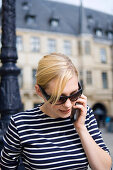 Young blond on the cell in front of Grand Ducal Palace, Luxembourg