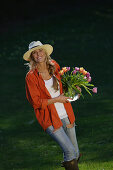 Young woman holding a bunch of tulips, Upper Bavaria, Bavaria, Germany