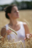 Mid adult woman standing in a corn field, , Carinthia, Austria